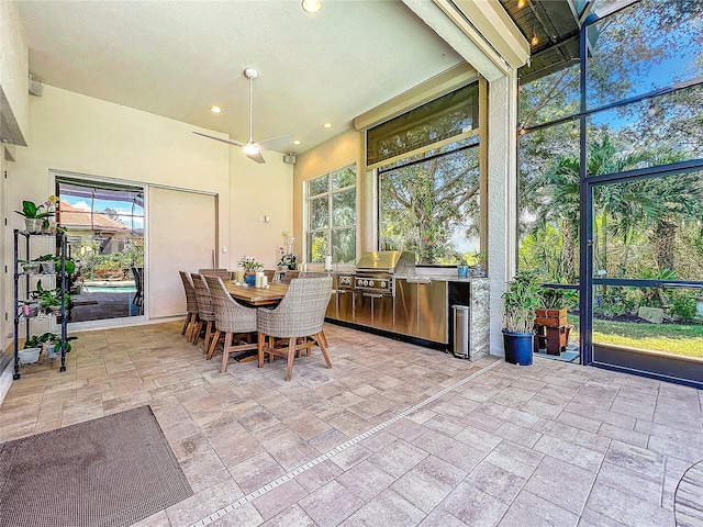 unfurnished sunroom featuring ceiling fan