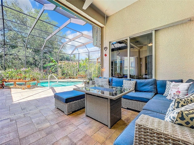 view of patio with an outdoor hangout area and glass enclosure