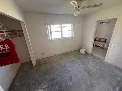 unfurnished bedroom with concrete flooring and ceiling fan