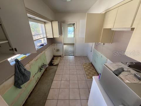 kitchen featuring white cabinetry and light tile patterned floors