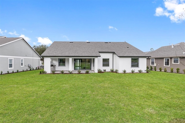 back of house with a lawn