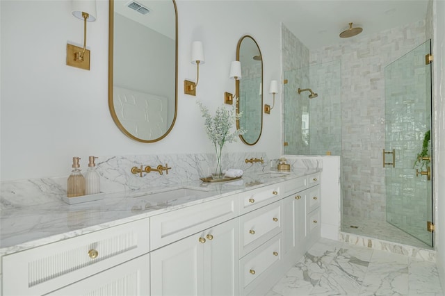 bathroom featuring vanity and a shower with shower door