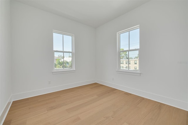 unfurnished room with plenty of natural light and light hardwood / wood-style floors