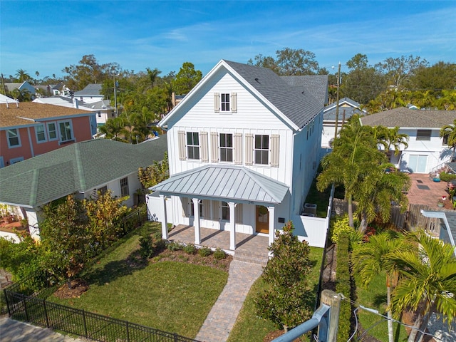 view of front of house with a front yard and covered porch