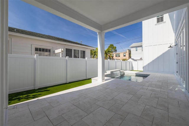 view of patio / terrace with a fenced in pool