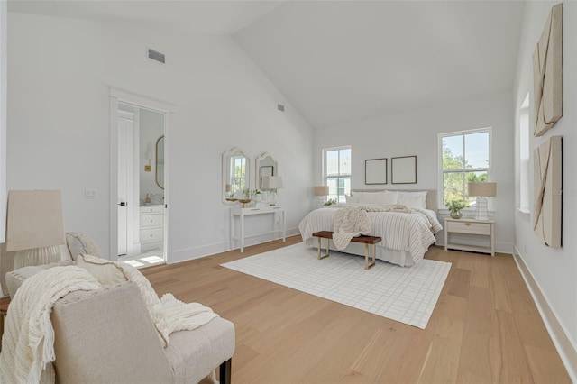 bedroom featuring high vaulted ceiling and light wood-type flooring