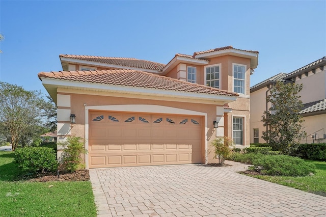 18051 Java Isle Dr, Tampa, FL 33647 - mediterranean / spanish-style home with stucco siding, decorative driveway, an attached garage, and a tile roof