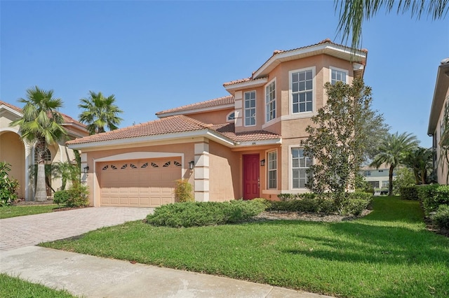 mediterranean / spanish-style home with a garage and a front lawn