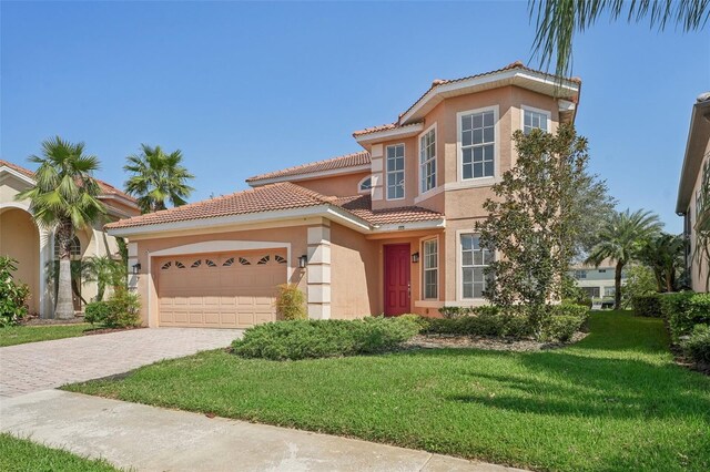 18051 Java Isle Dr, Tampa, FL 33647 - mediterranean / spanish-style home with stucco siding, a tile roof, an attached garage, decorative driveway, and a front yard