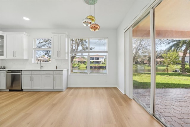 18051 Java Isle Dr, Tampa, FL 33647 - kitchen with dishwasher, healthy amount of natural light, light countertops, white cabinetry, and recessed lighting
