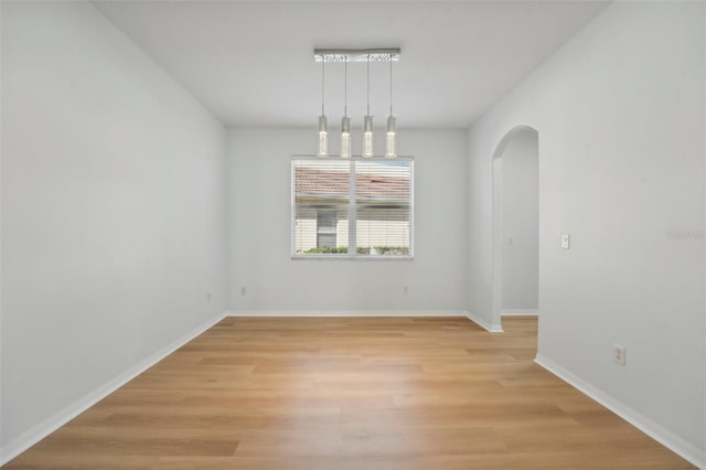 spare room featuring light wood-type flooring