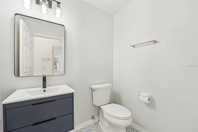 bathroom with vanity, toilet, and tile patterned floors