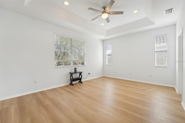 18051 Java Isle Dr, Tampa, FL 33647 - unfurnished room with a tray ceiling, a ceiling fan, light wood-style floors, baseboards, and recessed lighting