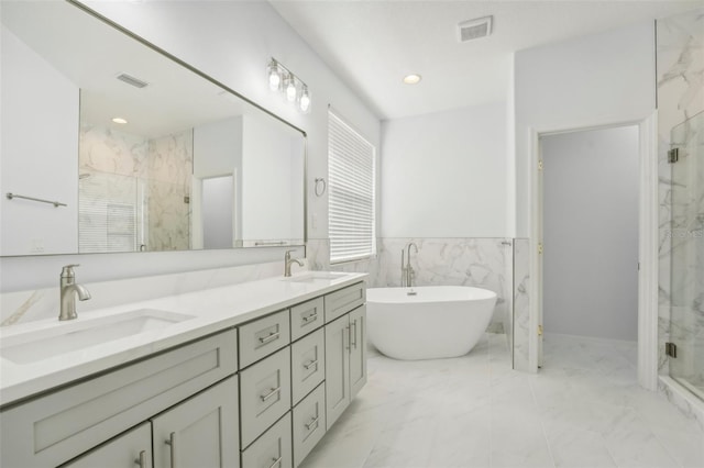 bathroom featuring vanity, tile walls, shower with separate bathtub, and plenty of natural light