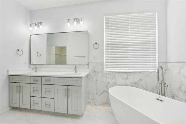 bathroom with a bath, tile walls, and vanity