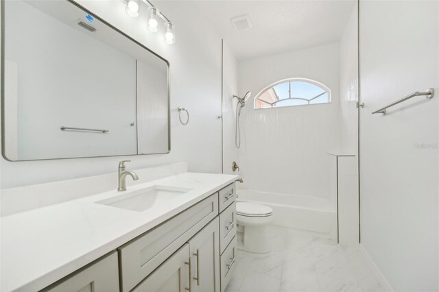 full bathroom featuring toilet, vanity, and  shower combination