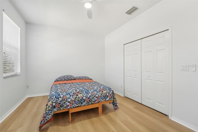 bedroom featuring hardwood / wood-style flooring, a closet, and ceiling fan