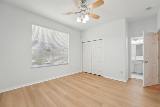 unfurnished bedroom featuring light hardwood / wood-style flooring, a closet, and ceiling fan