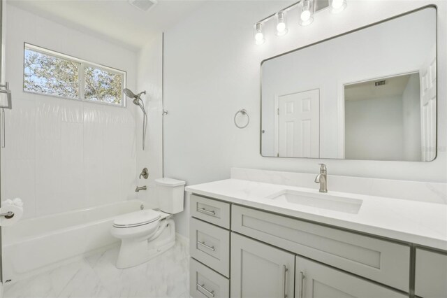 18051 Java Isle Dr, Tampa, FL 33647 - bathroom featuring marble look tiles, vanity, toilet, and bathtub / shower combination