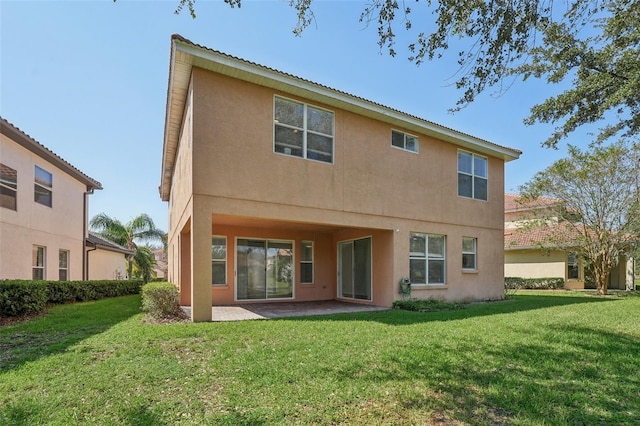 rear view of property featuring a patio and a lawn