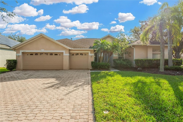 view of front of property with a front yard and a garage