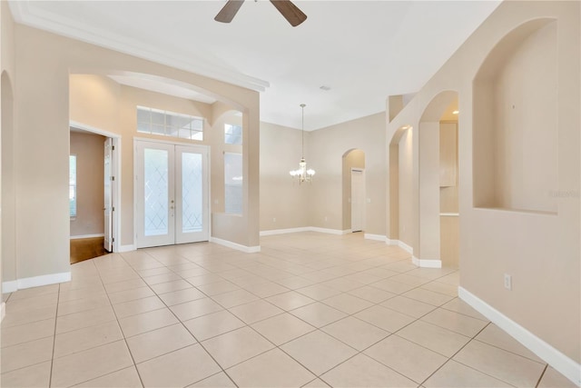 entrance foyer featuring french doors, ceiling fan with notable chandelier, and light tile patterned floors