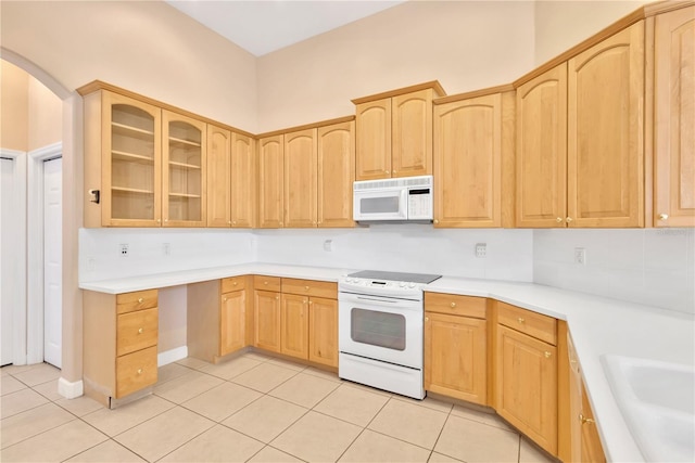 kitchen with sink, light brown cabinets, white appliances, and light tile patterned floors