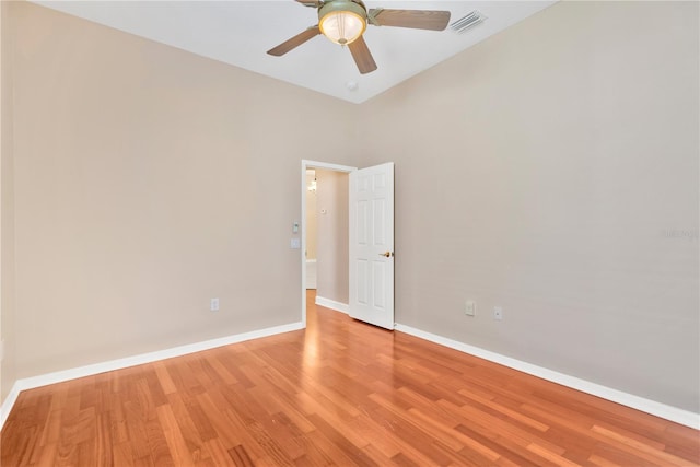 empty room featuring high vaulted ceiling, light wood-type flooring, and ceiling fan