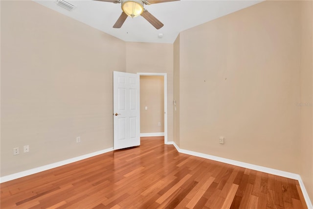 spare room with ceiling fan, high vaulted ceiling, and hardwood / wood-style floors