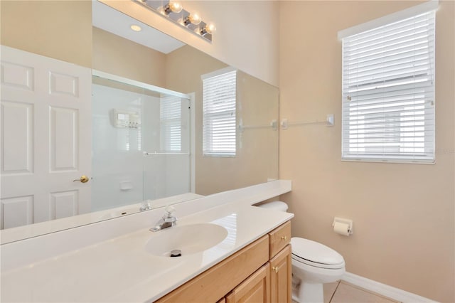 bathroom with vanity, a shower with shower door, toilet, and tile patterned floors