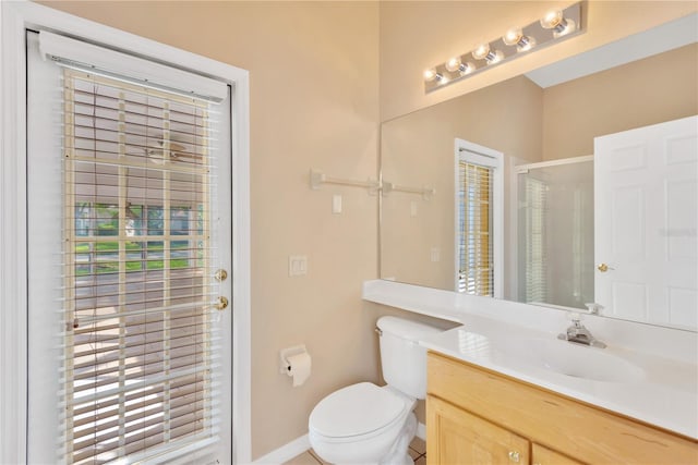 bathroom featuring vanity, toilet, and walk in shower