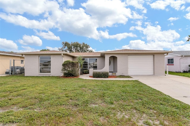 single story home with an attached garage, driveway, a front yard, and stucco siding