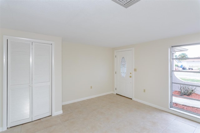 foyer entrance featuring baseboards