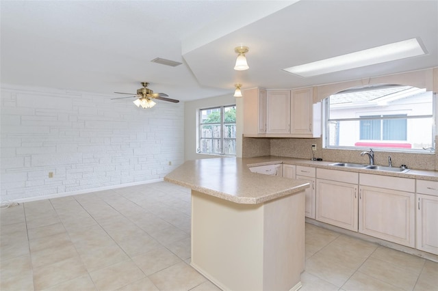 kitchen featuring light tile patterned floors, light countertops, visible vents, a sink, and ceiling fan