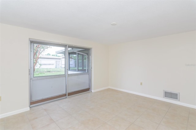 spare room featuring visible vents and baseboards