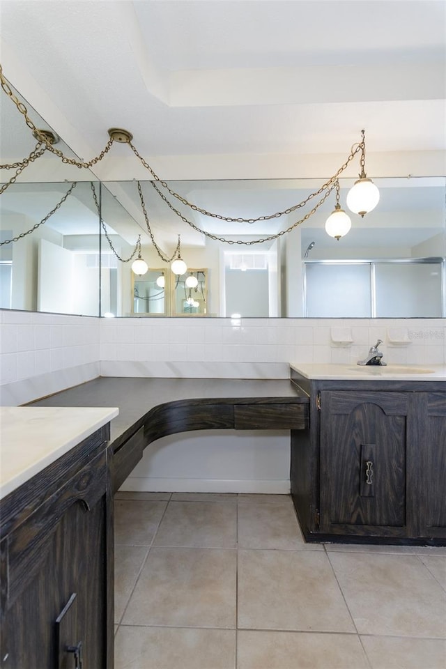 full bathroom with tile patterned floors, backsplash, and vanity