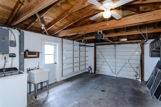 garage with a ceiling fan, washer / dryer, electric panel, and a garage door opener