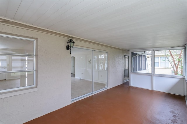 unfurnished sunroom with arched walkways