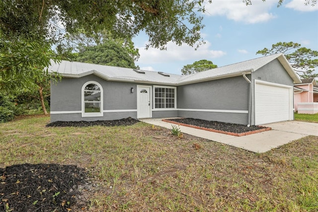 single story home featuring a front lawn and a garage