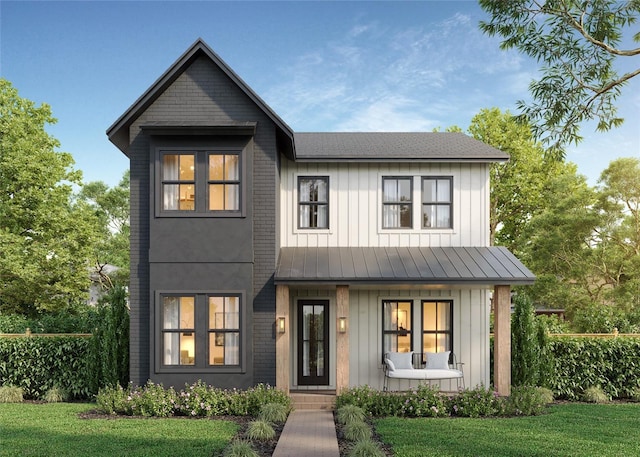 modern farmhouse style home featuring a porch, board and batten siding, a standing seam roof, and a front yard