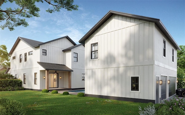 rear view of house featuring a yard and a garage