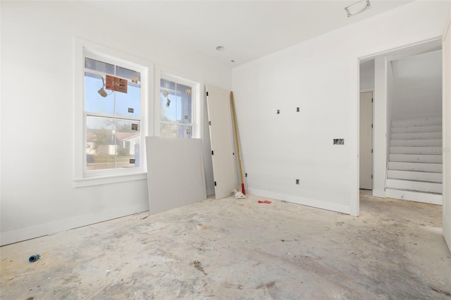 unfurnished room with concrete floors