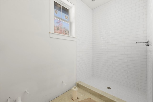 bathroom featuring tile patterned floors and tiled shower