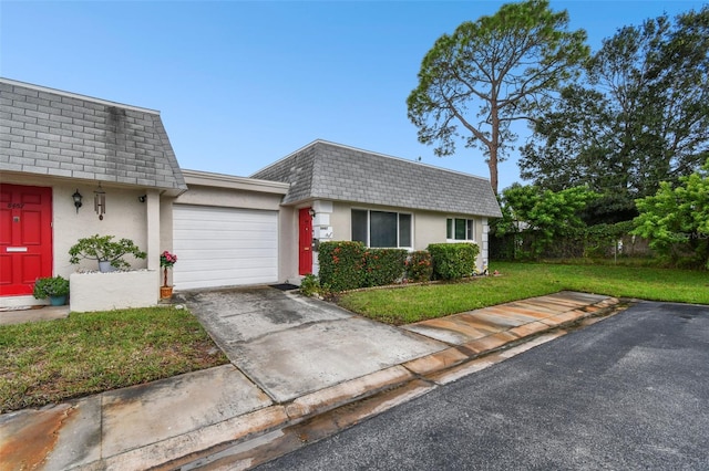 ranch-style house featuring a garage and a front lawn