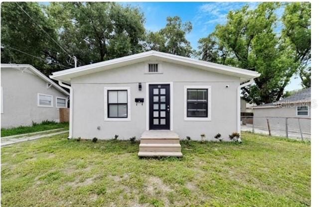 bungalow-style house with a front yard