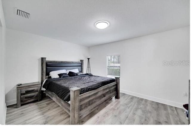 bedroom with light wood-type flooring