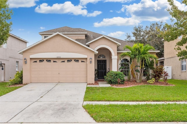 view of front facade featuring a front lawn and a garage