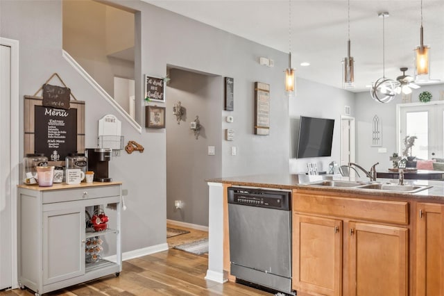 kitchen with ceiling fan, stainless steel dishwasher, light hardwood / wood-style flooring, pendant lighting, and sink