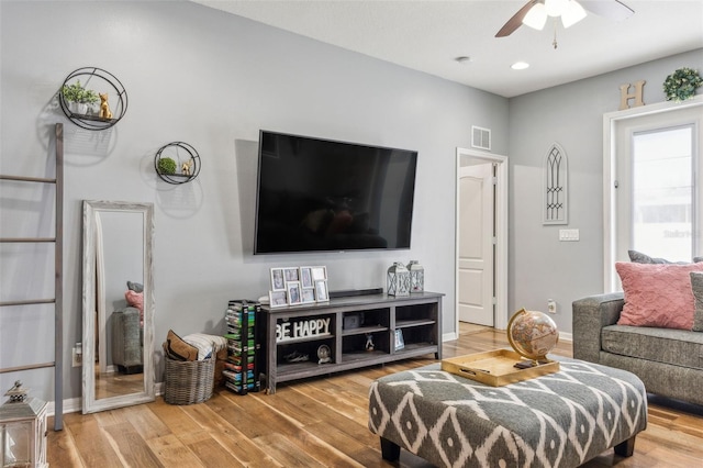 living room featuring ceiling fan and hardwood / wood-style floors