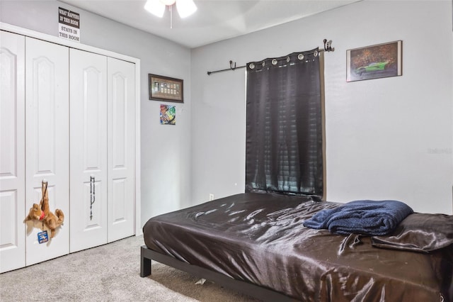 bedroom featuring a closet, light colored carpet, and ceiling fan